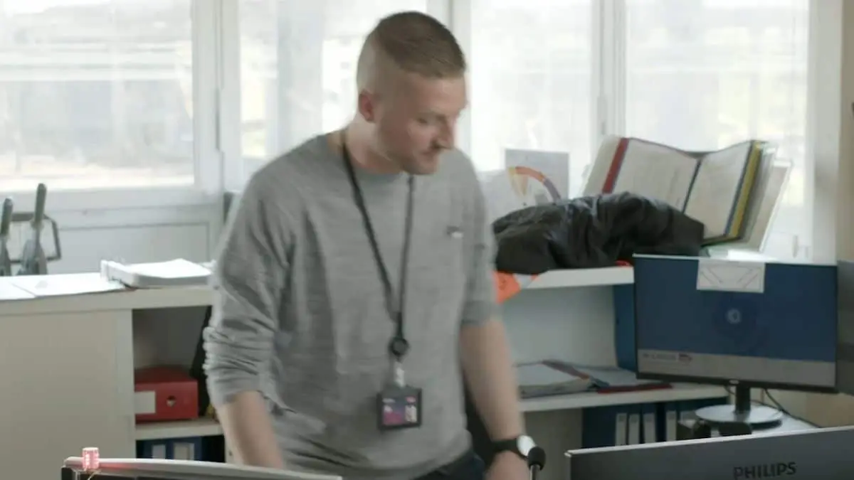 Vidéo interne SNCF : agent SNCF debout dans un bureau de circulation